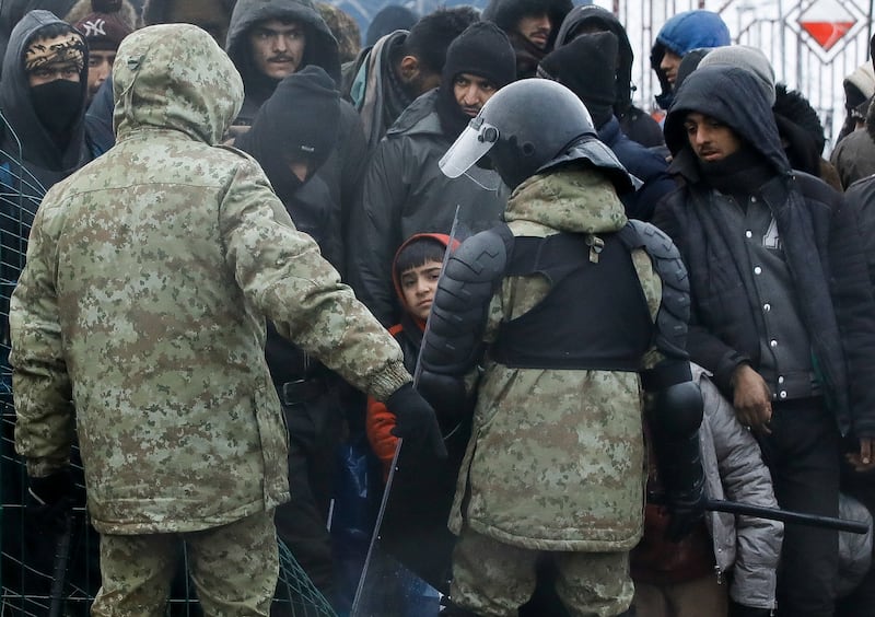 Belarusian law enforcement personnel in a migrant camp on the border with Poland. Reuters