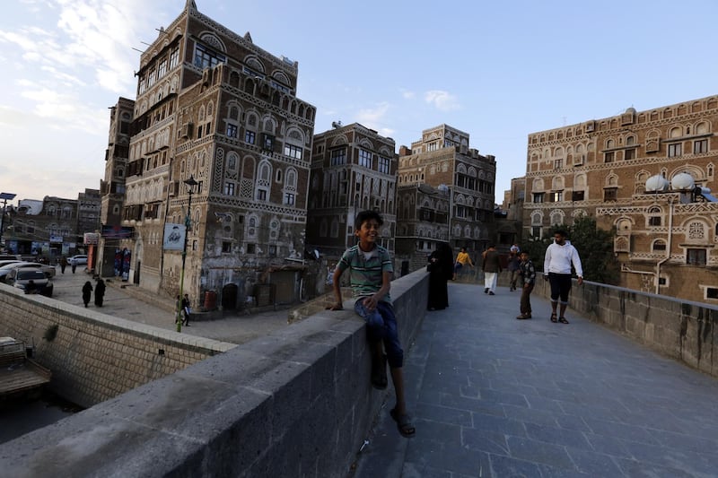 Yemenis walk through a pedestrian bridge during the sunset in the old quarter of Sana'a, Yemen. EPA