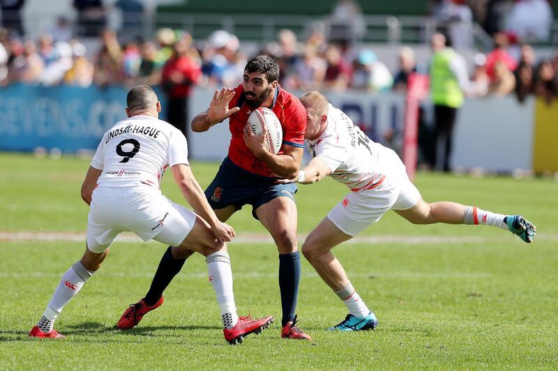 Dubai, United Arab Emirates - December 1st, 2017: Javier Carrion of Spain is tackled during the game between Spain and England at the 2nd Day of Dubai Rugby 7's. Friday, December 1st, 2017 at The Sevens, Dubai. Chris Whiteoak / The National