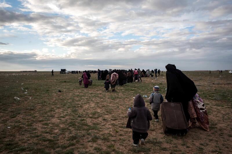 Families walk to be screened by Syrian Democratic Forces after fleeing from the last pocket of ISIS territory outside Baghouz,  Syria, 28 February 2019. Campbell MacDiarmid