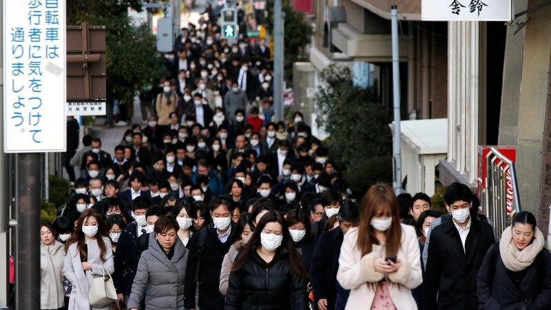 Commuters head to work in Tokyo, Japan. On average, people in Japan saved 44 per cent of their income in the five months through August this year. AP