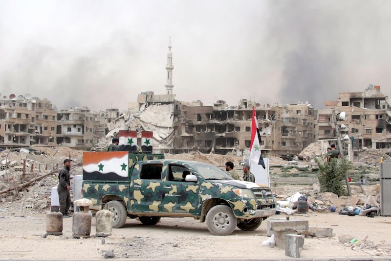 epa06755987 Syrian soldiers patrol at the Yarmouk Camp district in south Damascus, Syria, 22 May 2018. Media reports state the Syrian government of Bashar al-Assad on 21 May recaptured the last area of Damascus under opposition control and took full control of the capital for the first time since the outbreak of the civil war in 2011, after groups of Islamic State (IS) fighters holed up in an area of south Damascus, including the Palestinian refugee camp Yarmouk, were bussed out.  EPA/YOUSSEF BADAWI