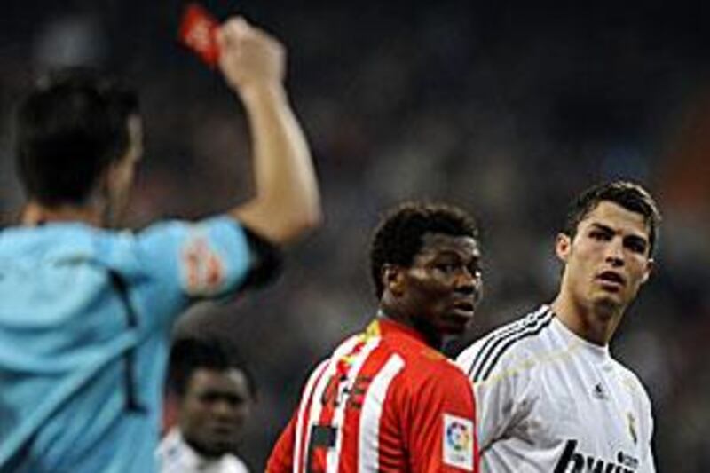 The referee shows a red card to Real Madrid's Cristiano Ronaldo, right, at the Bernabeu.