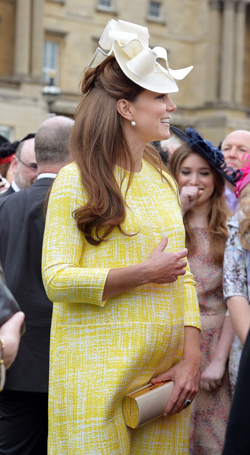 Catherine, Duchess of Cambridge, in yellow Emilia Wickstead, attends a garden party in the grounds of Buckingham Palace on May 22, 2013. Getty Images