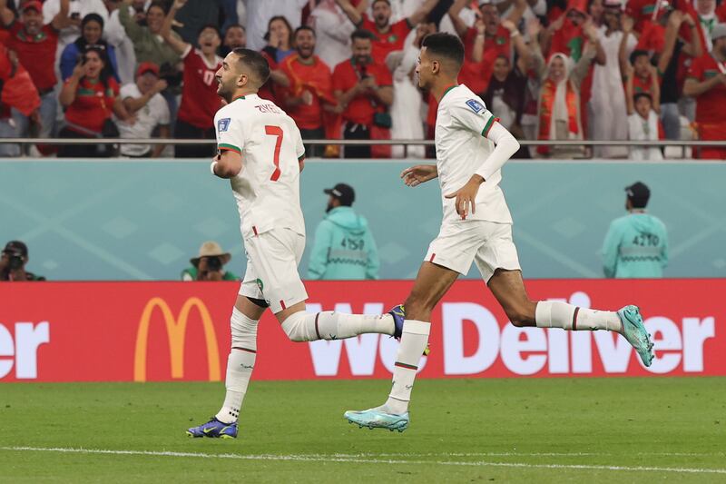 Hakim Ziyech celebrates with teammates after scoring. EPA