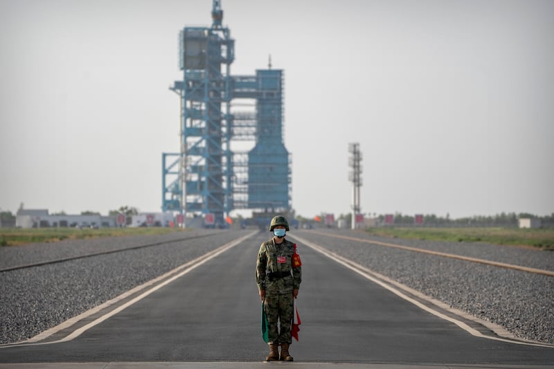 A security officer stands guard before the lift-off of the Shenzhou-16 spacecraft. AP
