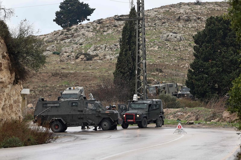 Israeli security forces block a road leading to the site of the shooting attack near Homesh. AFP