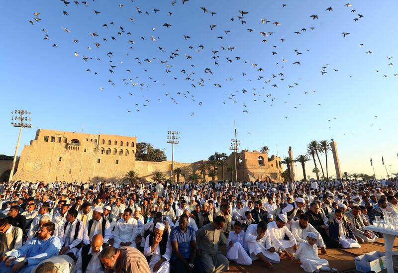 Libyan Muslim worshippers perform Eid al-Fitr prayers at the Martyrs' Square in the capital Tripoli on June 25, 2017 to mark the end of the fasting month of Ramadan. / AFP PHOTO / MAHMUD TURKIA