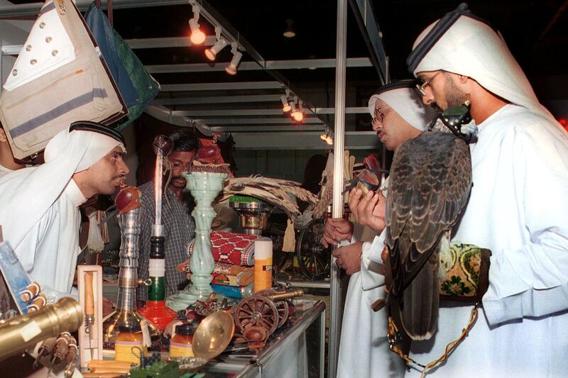 UAE nationals check handmade hoods for falcons during the Arab Hunting Show at the World Trade Centre in Dubai on September 26, 2000.