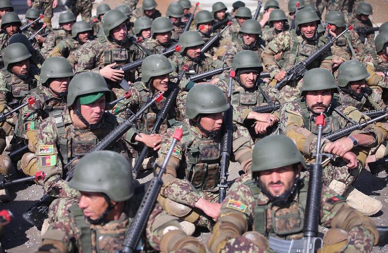 Soldiers with the Afghan National Army (ANA) wait for the start of their basic training graduation ceremony at the ANA’s combined fielding centre in Kabul. Scott Olson / Getty / March 18, 2014