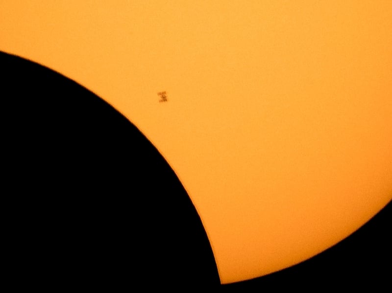 The International Space Station silhouetted against a partial eclipse. AP