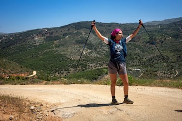 Nayla Cortas celebrates completing a section of the Lebanon Mountain Trail, near Marjaayoun, Lebanon on Saturday May 1 2021. Matt Kynaston for The National