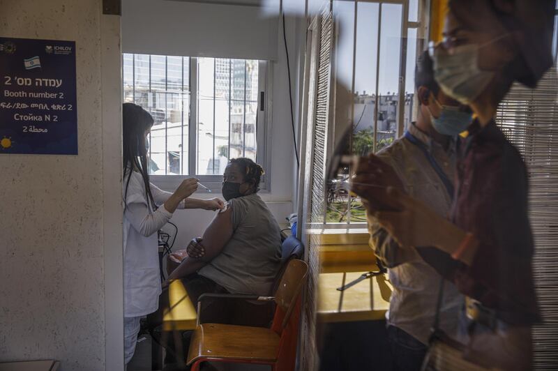 A foreign national receives a dose of the Pfizer-BioNTech Covid-19 vaccine at a vaccination centre in Tel Aviv. Bloomberg