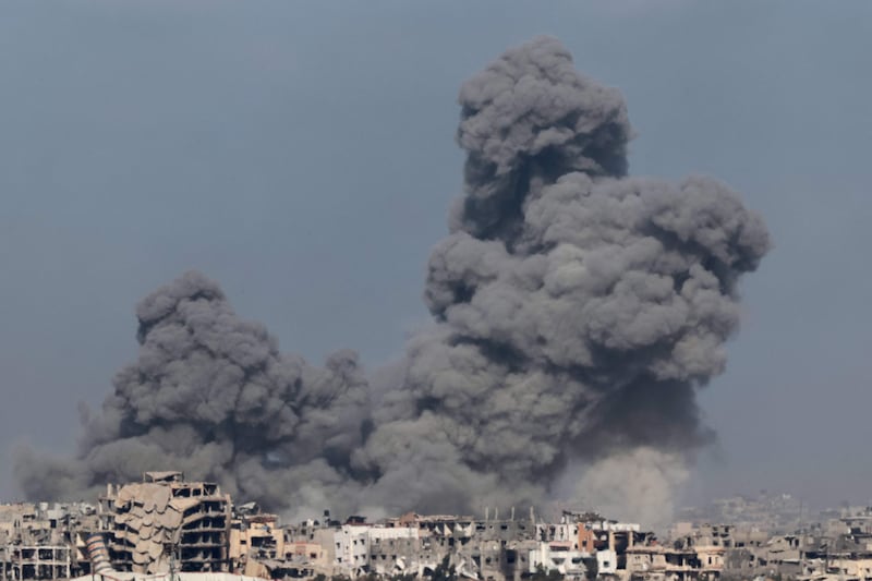 Smoke rises above buildings during an Israeli strike in Gaza. AFP