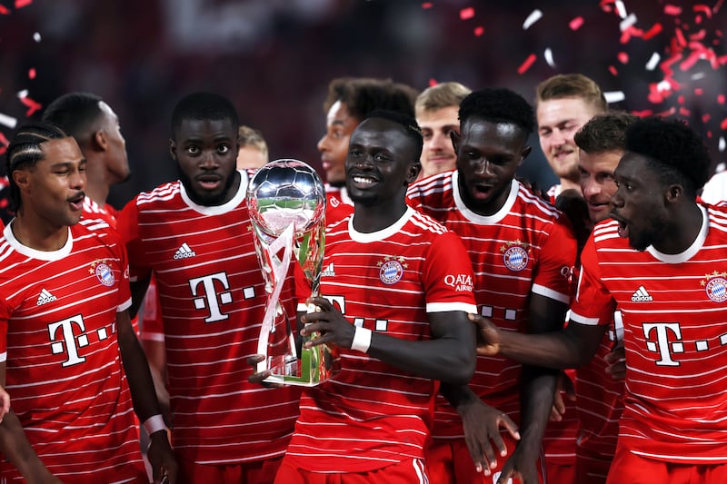 Sadio Mane celebrates with the Supercup trophy after Bayern's win over RB Leipzig. Getty