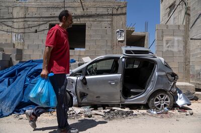 A charity worker delivers food aid to families affected by the Israeli military operation in the occupied West Bank refugee camp in Jenin. AP