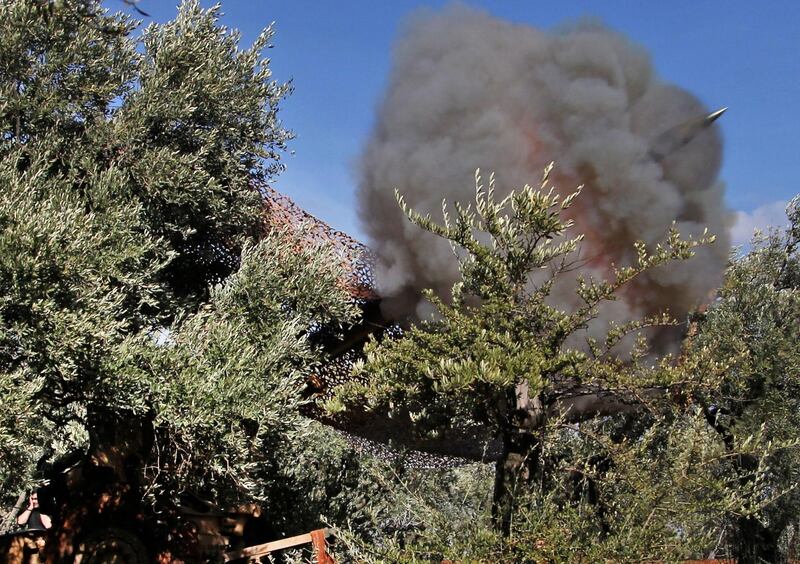 Turkish-backed Syrian fighters fire a shell at position near the village of al-Nayrab, about 14 kilometres southeast of the city of Idlib in northwestern Syria, amid clashes with government forces.   AFP