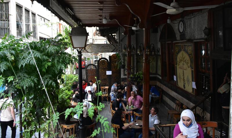 Customers sit on the terrace of a cafe in Damascus, Syria. EPA