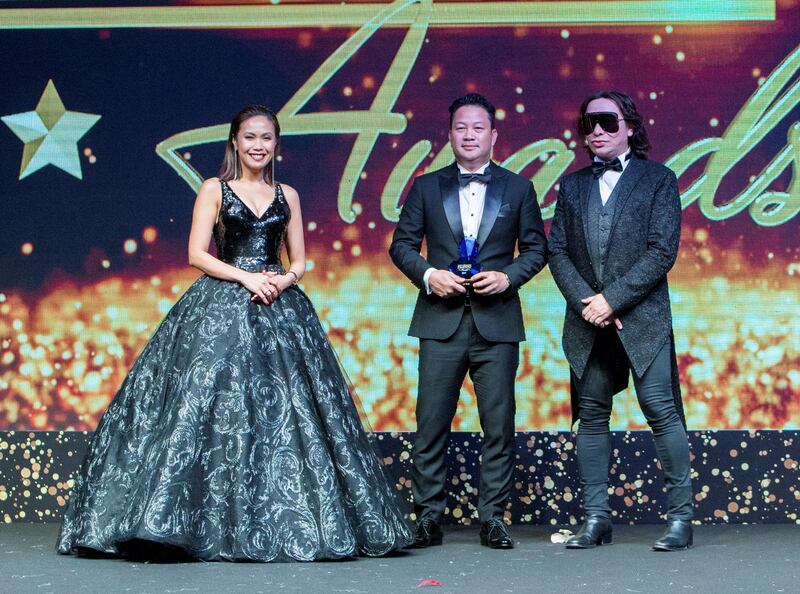 Dubai, United Arab Emirates- Andronico Del Rosario winner Artist of the Year Individual Category awarded by Karen Remo and fashion designer Michael Cinco at the Filipino Times award at Sofitel at The Palm.  Ruel Pableo for The National