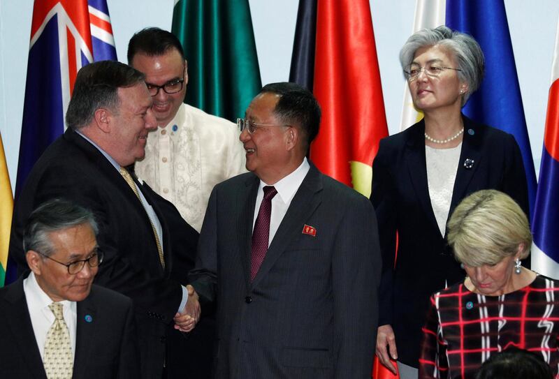 U.S. Secretary of State Mike Pompeo shakes hands with North Korea's Foreign Minister Ri Yong Ho as South Korea's Foreign Minister Kang Kyung-wha looks on at the Asean Regional Forum Retreat Session in Singapore August 4, 2018. REUTERS/Edgar Su