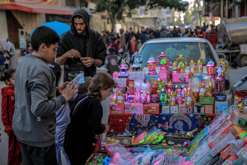 Palestinian children look at toys in Gaza city, amid the ongoing conflict between Israel and Hamas militants, as Ramadan nears.  AFP