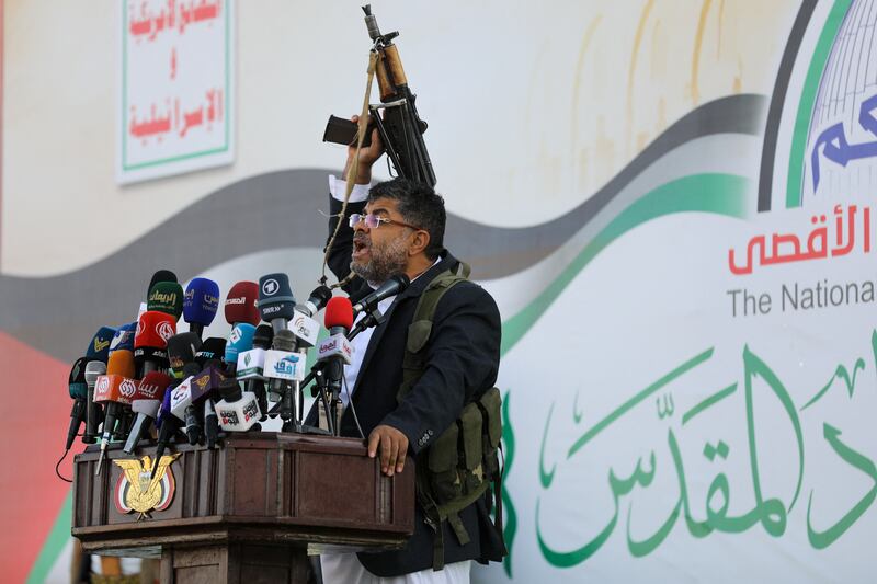 Mohammed Al Houthi, head of the Houthi supreme revolutionary committee, wields a gun as he speaks at a rally to denounce US-UK air strikes, in Sanaa. Reuters