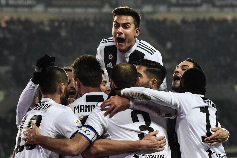 Juventus players celebrate after Cristiano Ronaldo scores a penalty. AFP