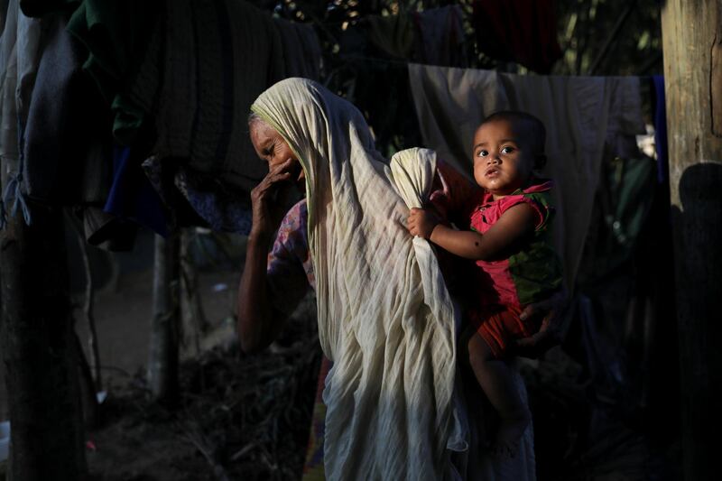 A Rohingya Hindu refugee woman holds a child inside their temporary shelter at the Kutupalong Hindu refugee camp near Cox's Bazar, Bangladesh December 17, 2017. REUTERS/Marko Djurica