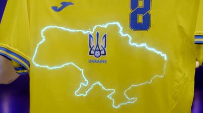 This handout photo taken from a video released by President of Ukrainian Association of Football Andrii Pavel Pavelko via Facebook, shows a new Ukraine's uniform for Ukrainian national soccer team that lights showing a map of Ukraine including Russian-annexed Crimea, Ukraine, Monday, June 7, 2021. Russian officials and lawmakers have denounced the design of the Ukrainian national soccer team's shirt for this month's European Championship. The yellow-and-blue Ukrainian uniform features a map of the country that includes Crimea. The Black Sea peninsula was annexed by Russia in 2014 following the ouster of its Moscow-friendly president. Most of the world hasn't acknowledged the annexation. (President of Ukrainian Association of Football Andrii Pavel Pavelko's Facebook account via AP)