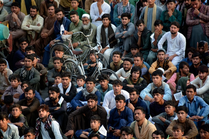 Fans watch the men's T20 World Cup semi-final cricket match between Afghanistan and South Africa, on a big screen in Jalalabad. AP