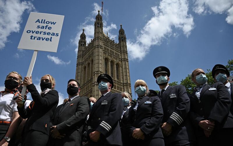 Representatives from the travel industry, including airline cabin crew and pilots, demonstrate during a 'Travel Day of Action' outside the Houses of Parliament in central London. AFP