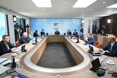 Britain's Prime Minister Boris Johnson, center, with from left, Italy's Prime Minister Mario Draghi, Australia's Prime Minister Scott Morrison, German Chancellor Angela Merkel, South Africa's President Cyril Ramaphosa, South Korea's President Moon Jae-in, US President Joe Biden, French President Emmanuel Macron, Canada's Prime Minister Justin Trudeau, Japan's Prime Minister Yoshihide Suga and President of the European Council Charles Michel at the G7 summit in Cornwall, England. AP