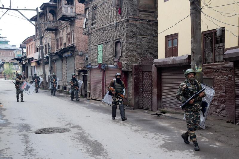 Indian paramilitary soldiers patrol a deserted street in Srinagar. AP Photo