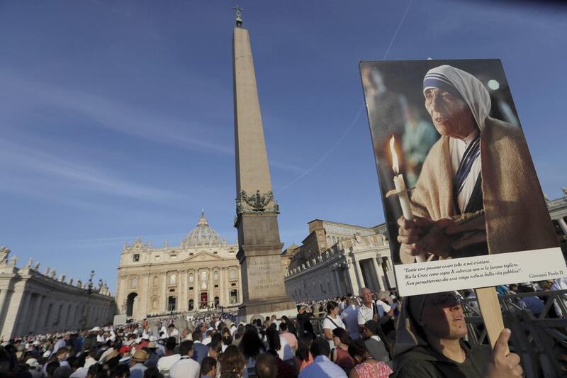 A nun holds a photo of Mother Teresa at the canonisation ceremony in St Peter’s Square at the Vatican on September 4, 2016. Alessandra Tarantino / AP Photo