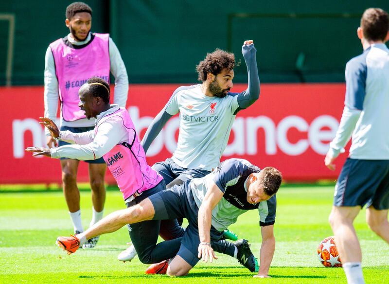 Liverpool players (L-R) Sadio Mane, Mohamed Salah, and James Milner perform during their team's training session at Melwood.  EPA
