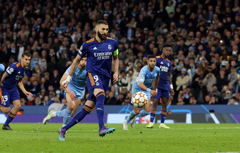 Karim Benzema scores Real Madrid's third goal from the penalty spot during the Champions League semi-final first leg against Manchester City at the Etihad on April 26, 2022. Reuters