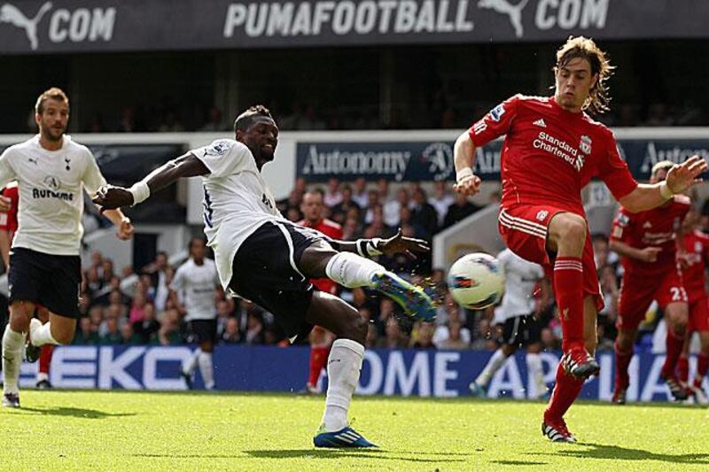 Emmanuel Adebayor shoots and scores Tottenham's fourth goal in their 4-0 victory against nine-man Liverpool at White Hart Lane.

Clive Rose / Getty Images