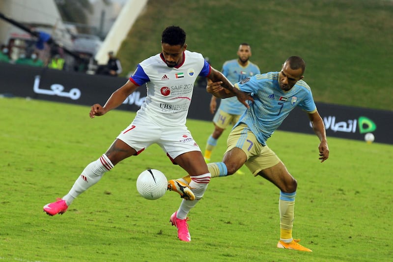 Sharjah’s Brazilian forward Caio, left, shields the ball from Al Dhafra’s Mohammed Hassan. Courtesy UAE FA