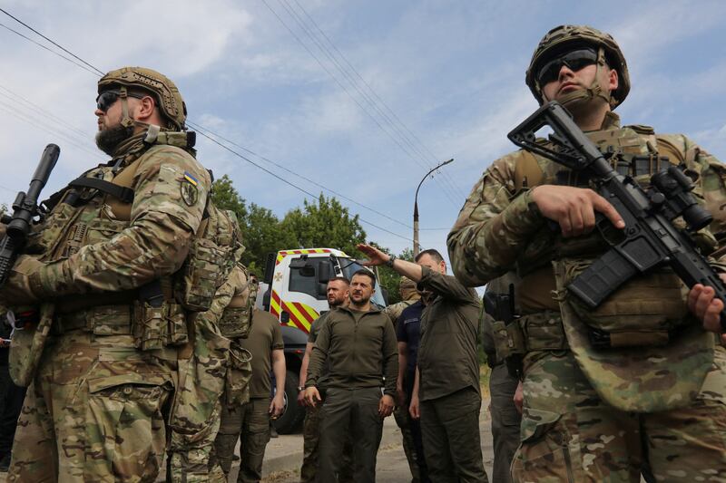 Ukraine's President Volodymyr Zelenskyy visits an area that was flooded after Kakhovka dam was bombed. Reuters