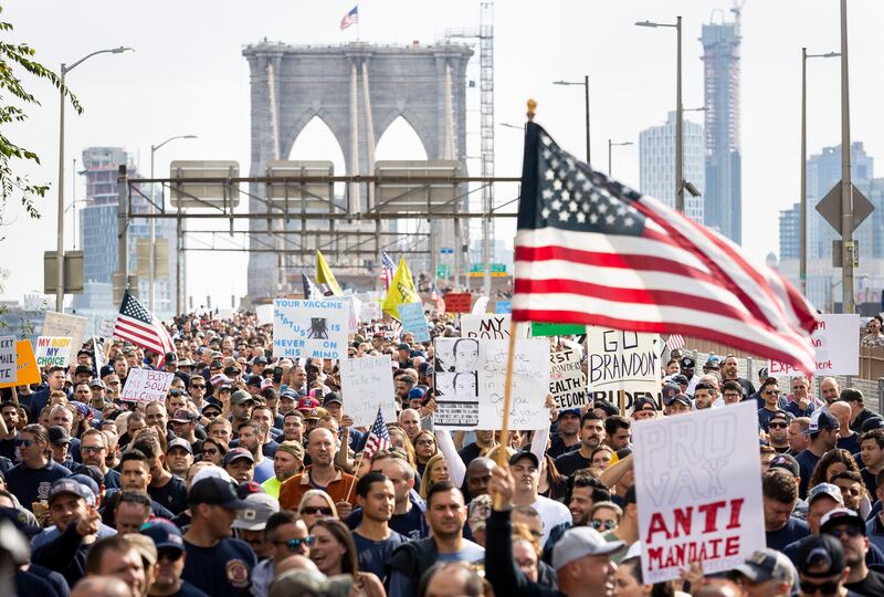 Hundreds of people march across the Brooklyn Bridge during a protest against the Covid-19 vaccination mandates for municipal employees in New York. EPA