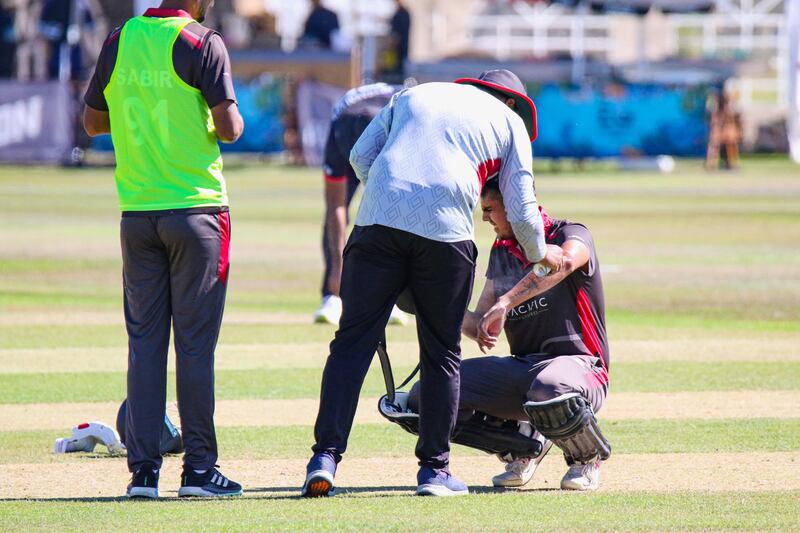 UAE batter Aryan Lakra gets treatment after being hit on the arm. 