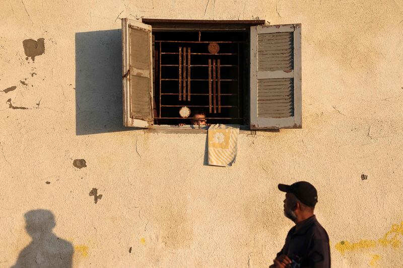 A Palestinian boy peeks from a window in Gaza city. AFP