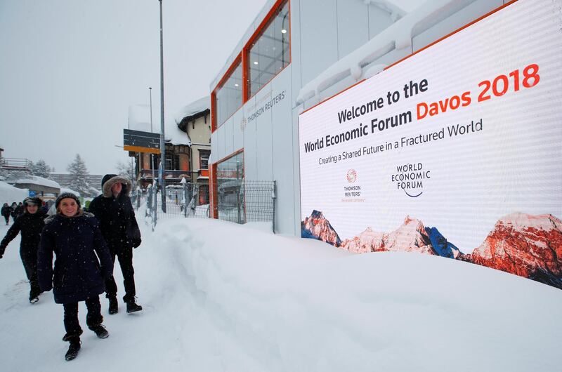 People walk in the snow ahead of the World Economic Forum (WEF) annual meeting in the Swiss Alps resort of Davos, Switzerland January 21, 2018  REUTERS/Denis Balibouse