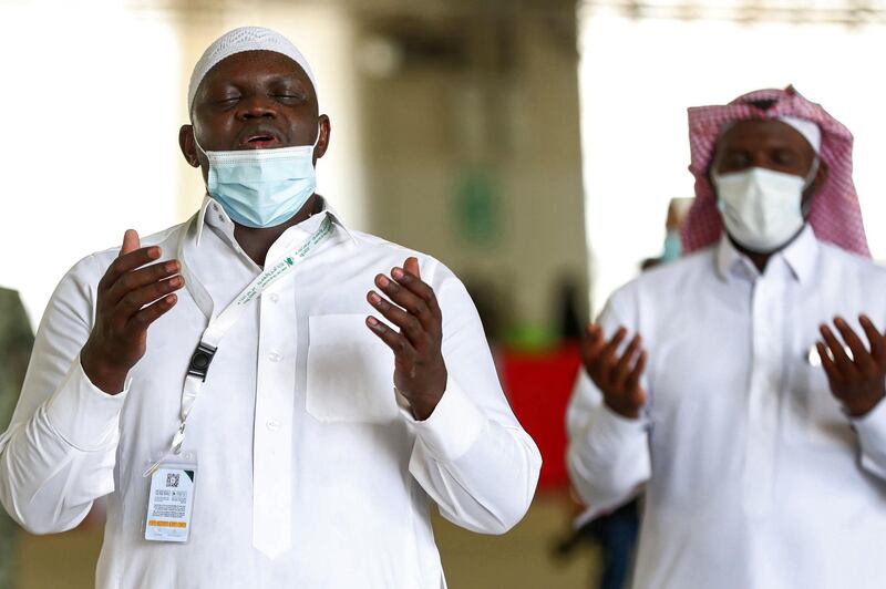 Muslim pilgrims, clad in face masks due to the COVID-19 coronavirus pandemic, pray after throwing pebbles as part of the symbolic al-A'qabah (stoning of the devil ritual) at the Jamarat Bridge during the Hajj pilgrimage in Mina.   AFP