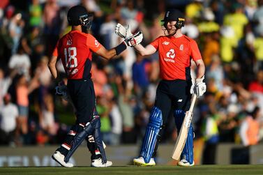 Eoin Morgan, right, and Moeen Ali celebrate England's victory during the third T20 against South Africa in Centurion on Sunday. Getty Images