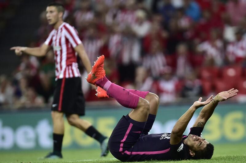 Barcelona’s Luis Suarez laments on the pitch next to Athletic Bilbao’s Aymeric Laporte. Alvaro Barrientos / AP Photo