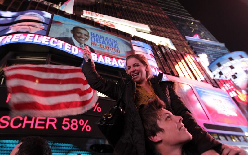 TOPSHOTS
People celebrate in Times Square as it is announced that President Obama has been re-elected during the 2012 Presidential Election in New York, New York on November 6, 2012. AFP PHOTO/Mehdi Taamallah
 *** Local Caption ***  839088-01-08.jpg