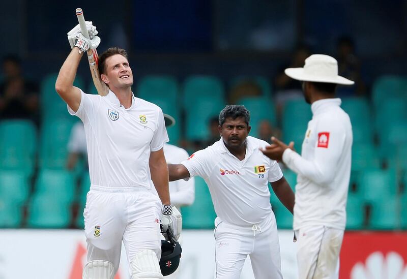 Cricket - Sri Lanka v South Africa -Second Test Match - Colombo, Sri Lanka - July 23, 2018 - South Africa's Theunis de Bruyn (L) celebrates his century next to Sri Lanka's Rangana Herath. REUTERS/Dinuka Liyanawatte