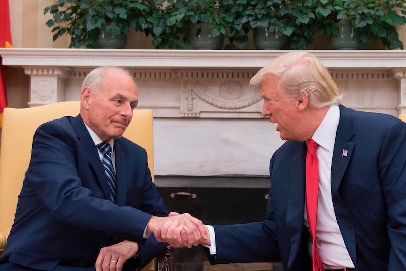 TOPSHOT - US President Donald Trump (R) shakes hands with newly sworn-in White House Chief of Staff John Kelly at the White House in Washington, DC, on July 31, 2017.  
US President Trump on July 28, 2017 announced via Twitter that he had picked Kelly to replace outgoing chief of staff Reince Priebus, rumored for weeks to be on the verge of being sacked. The chief of staff traditionally manages the president's schedule and is the highest ranking White House employee, deciding who has access to the president. 
 / AFP PHOTO / JIM WATSON