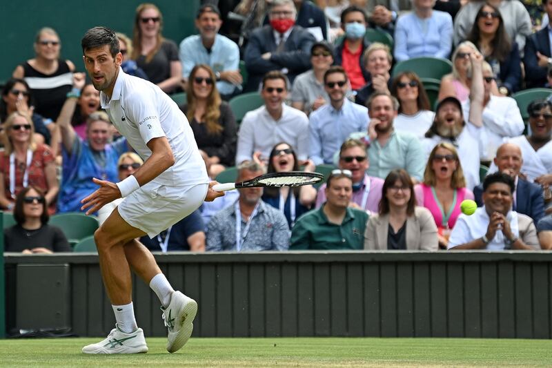 Novak Djokovic plays an unorthodox return. AFP